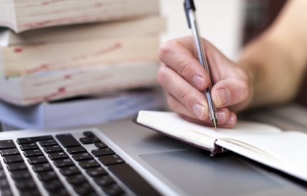 image of man writing on paper